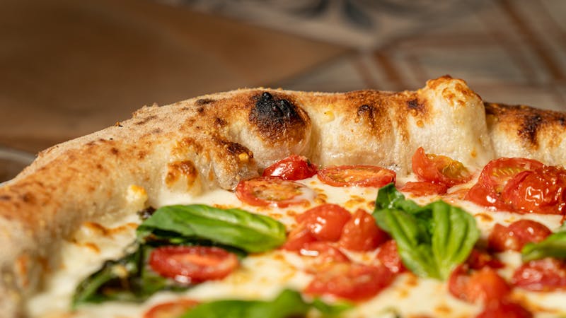 Classic Margherita pizza with fresh basil and mozzarella