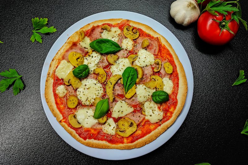 Prosciutto and arugula gourmet pizza on wooden board